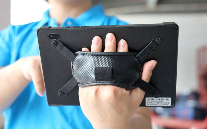 Rear view of a warehouse rugged tablet with hand strap for comfortable one-handed operation during inventory management.
